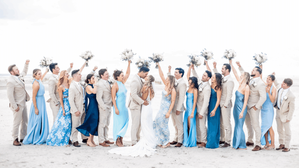 Wedding party in light, airy clothing on a beach