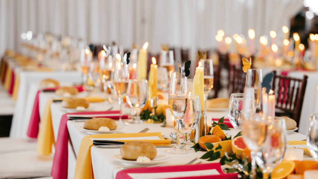 Wedding reception table set with bright colored linens and decorations