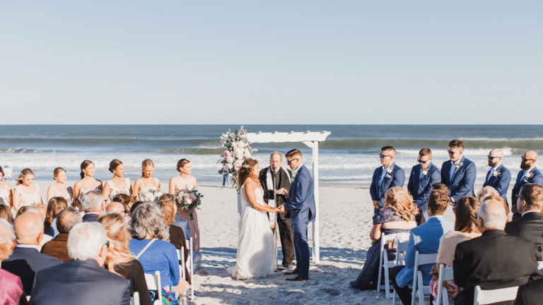 Beach wedding ceremony with the ocean in the background