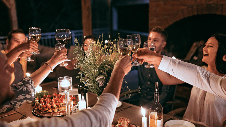 Friends toasting at a rehearsal dinner