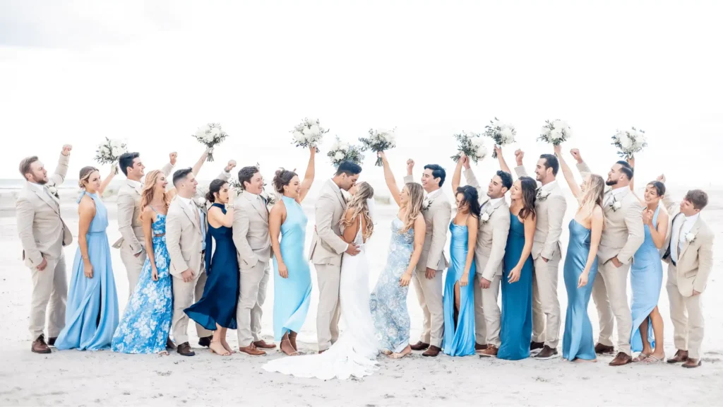 Wedding party in light, airy clothing on a beach