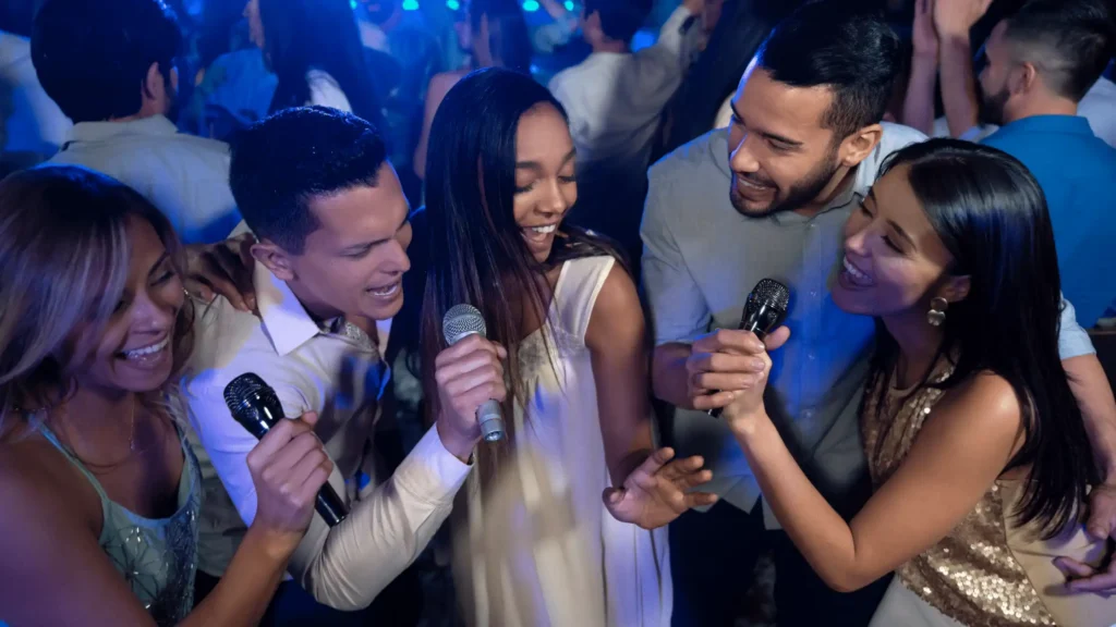 Guests singing karaoke at a wedding reception