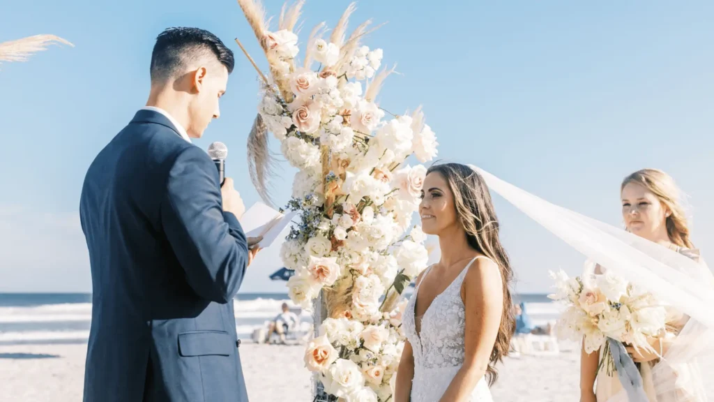 Groom reading vows to his bride on the beach