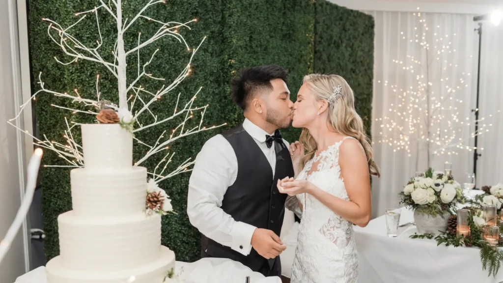 Bride and groom kissing at their winter wedding reception