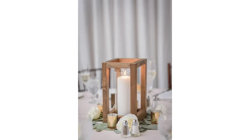 Wooden lantern holding a candle as wedding table decor