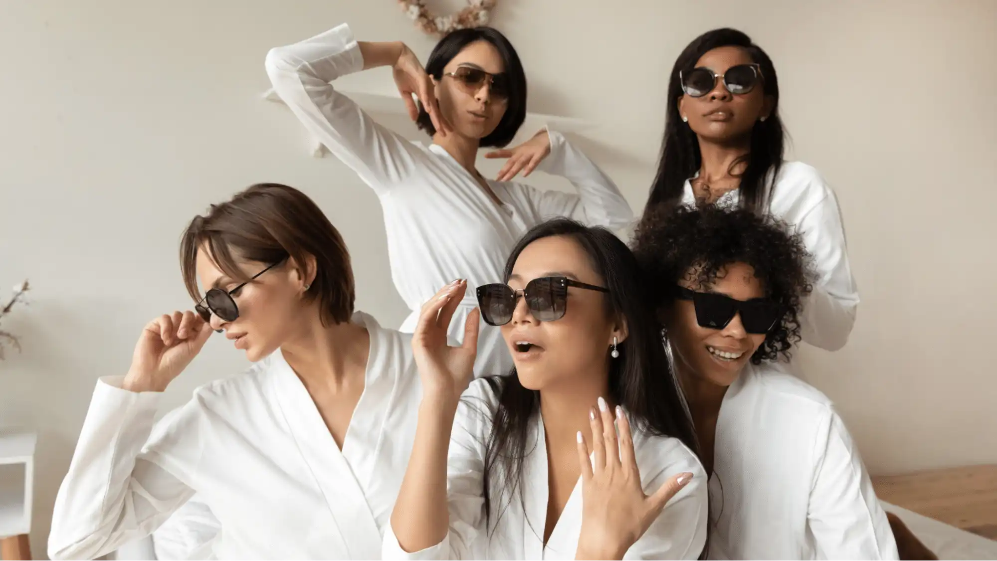Bridesmaids in robes wearing sunglasses