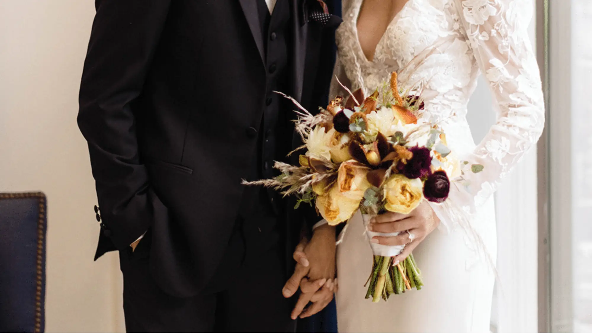 Bridal bouquet including white dahlias with deep red and golden flowers